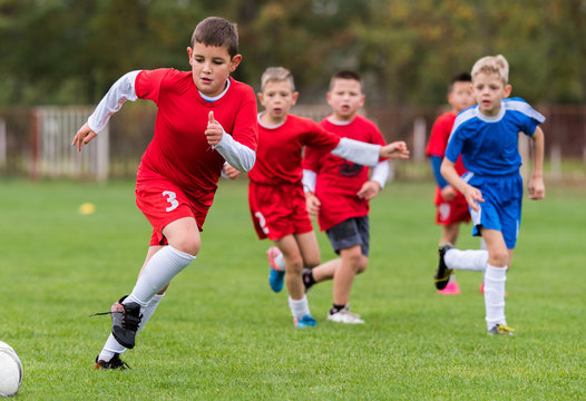 Young children players football match on soccer field