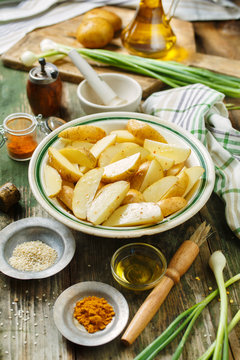 Raw potatoes with spices and green onions, ingredients for cooking