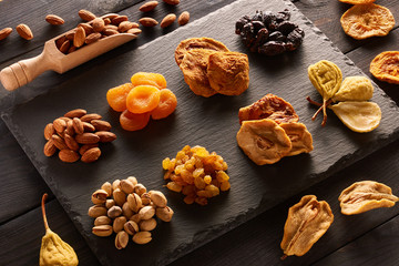 Fototapeta premium Dried fruits and nuts on slate plate