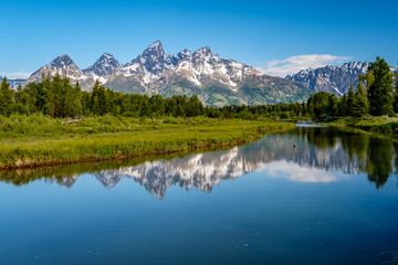 Obraz na płótnie Canvas Mountains in Grand Teton National Park with reflection in Snake River