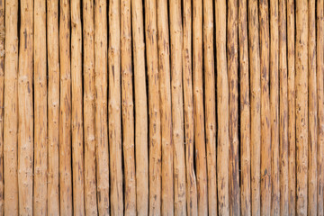 wooden wall from vertical logs, background texture