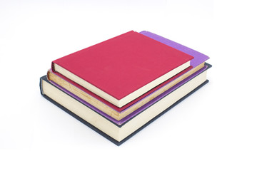 Pile of different colored books, stacked and arranged, isolated on white