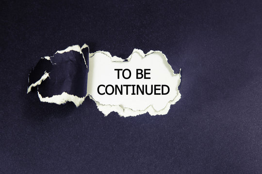 The text to be continued appearing behind torn paper