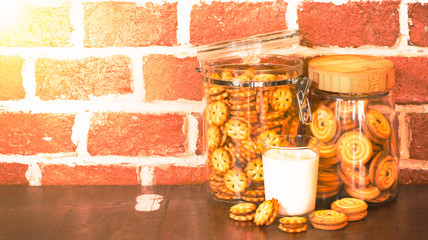 Cookies in the jars with a cup of milk