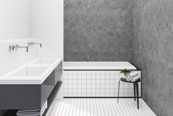 Concrete and white bathroom, tiled tub