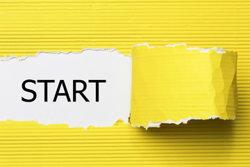 The word start written on torn paper