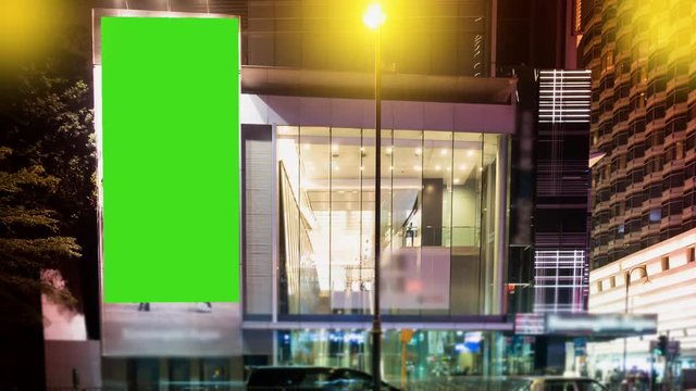 Time Lapse.A Billboard with a Green Screen on a Evening Streets of Hong Kong .
