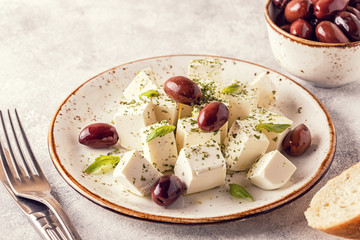 Greek cheese feta with oregano and olives.