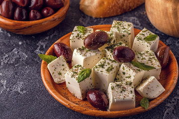 Greek cheese feta with oregano and olives.