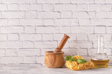 Products for cooking - pasta, tomatoes, garlic, olive oil, basil.