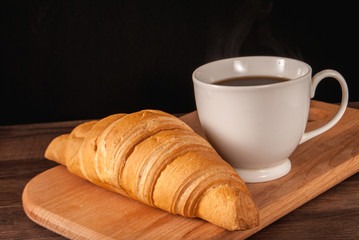 croissant and a cup of coffee