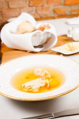 Dumplings in broth with an egg yolk served in a restaurant