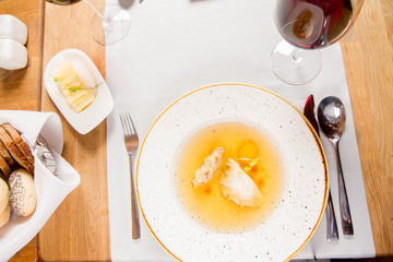 Dumplings in broth with an egg yolk served in a restaurant