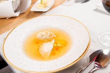 Dumplings in broth with an egg yolk served in a restaurant