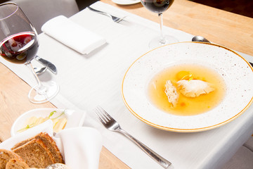 Dumplings in broth with an egg yolk served in a restaurant
