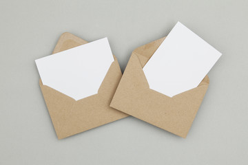 Blank white card with kraft brown paper envelope template mock up