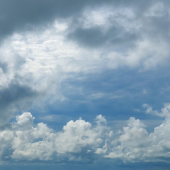 Cumulus clouds against the blue sky.