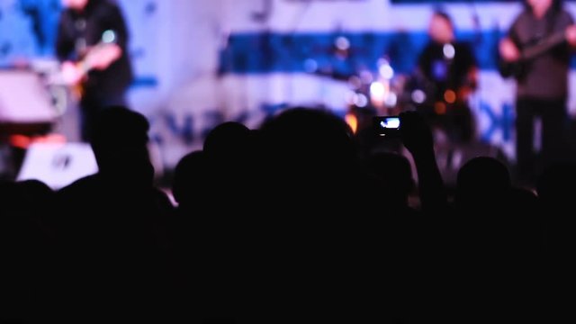 people shoot a concert on their phones