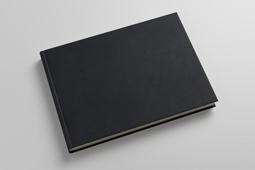 Empty black book on gray background