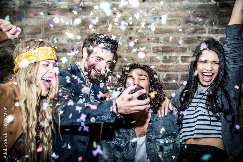 Wall mural group of young adults hanging around in a disco club