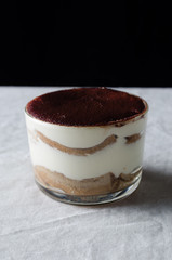 Tiramisu in a glass cup.
