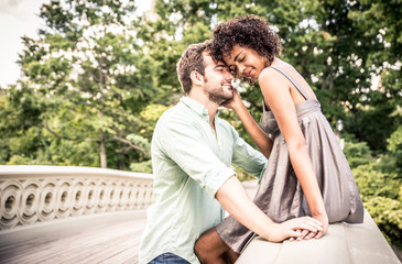 Fototapeta premium Happy smiling couple in Central park. Enjoying time on the bow bridge