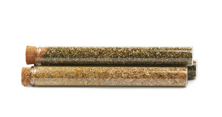 Herbal spices in a glass vial isolated