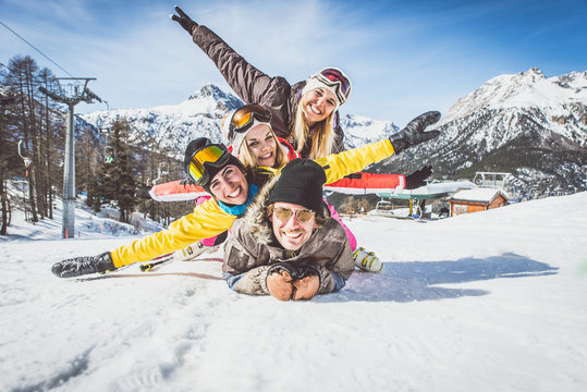 Group of friends having fun on the snow