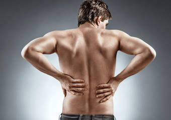 Fototapeta premium Kidneys pain or lower back pain. Man holding his back. Medical concept.