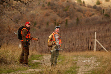 hunters with dogs hunting a bird woodcock