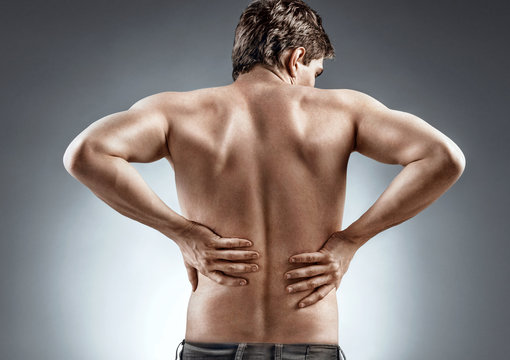 Kidneys pain or lower back pain. Man holding his back. Medical concept.