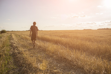 Guy is walking around the field