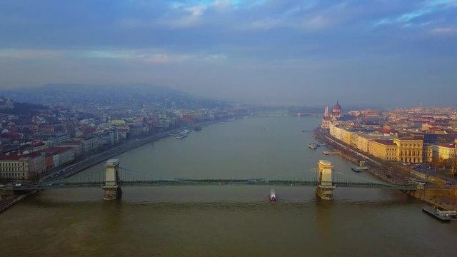 Budapest, Hungary - 4K aerial drone footage of the famous Szechenyi Chain Bridge with Parliament of Hungary at sunset
