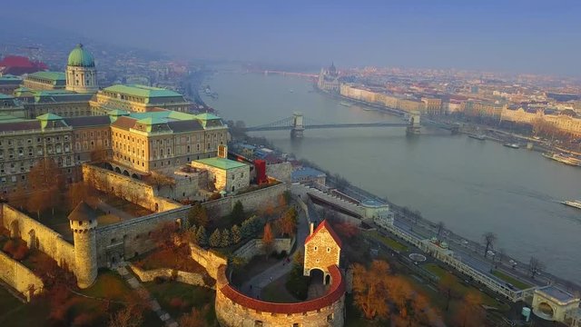 Budapest, Hungary - 4K aerial drone footage of Buda Castle Royal Palace with famous Szechenyi Chain Bridge and Parliament of Hungary at sunset