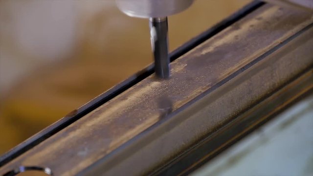 Bending flat metal then make a hole at flat bar by drilling machine. lose up tool of automatic drilling machine make hole at metal with cooling by coolant water and evaporate to steam