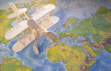 Fototapeta na wymiar toy wooden plane on the background of the map. Concept travel, tourism.