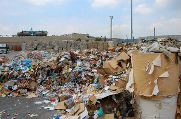 The mountain of waste paper and bales of garbage at the waste processing plant