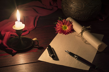 The candle illuminates the Desk where the letter