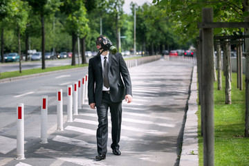 Businessman wearing a gas mask looking to the sky