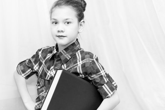 Beautiful Child Holding A Book Under His Arm