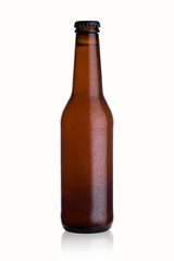Brown glass beer bottle with black cap with dew