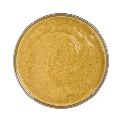 Mustard in glass bowl isolated on white background. Top view