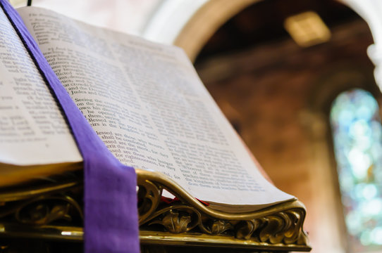 Bible on pulpit in a cathedral, open at Matthew Chapter 5.