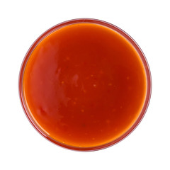 Hot chilli sauce in bowl isolated on white background. Top view