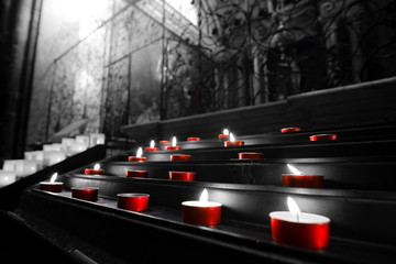 red votive candles church tealights selective color black and white