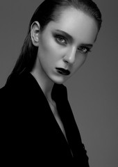 Fototapeta premium Fashion model with wet hair wearing black coat