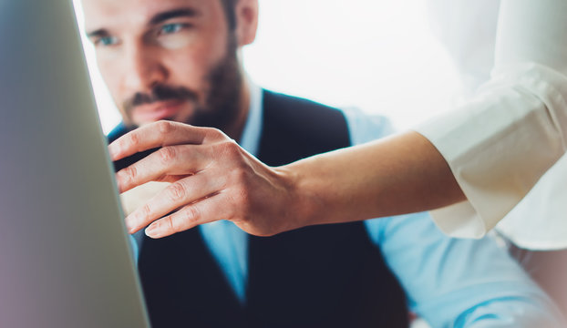 Bearded young businessman working on office. Director man thinking looking in monitor computer. Managers meeting. Idea, alalyze marketing plans. Workplace concept, startup project with colleague