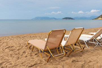 Fototapeta na wymiar Sunbeds and parasols on beautiful Gerakas beach. Zakynthos island. Greece.