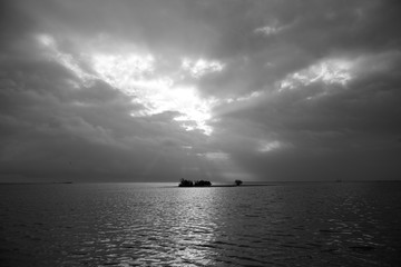 Offshore island, clouds and sky on calm waters of the Gulf of  Mexico near Rockport, Texas 