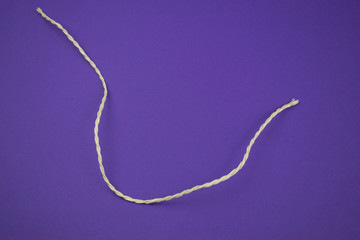 String on colorful ultra violet background, copy space